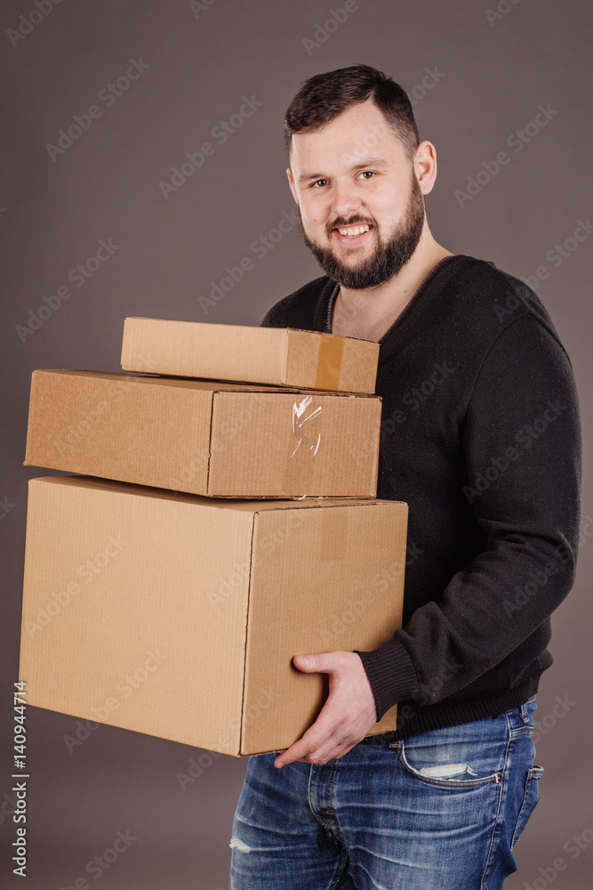 man holding pile of cardboard boxes in front man holding pile of cardboard boxes in front