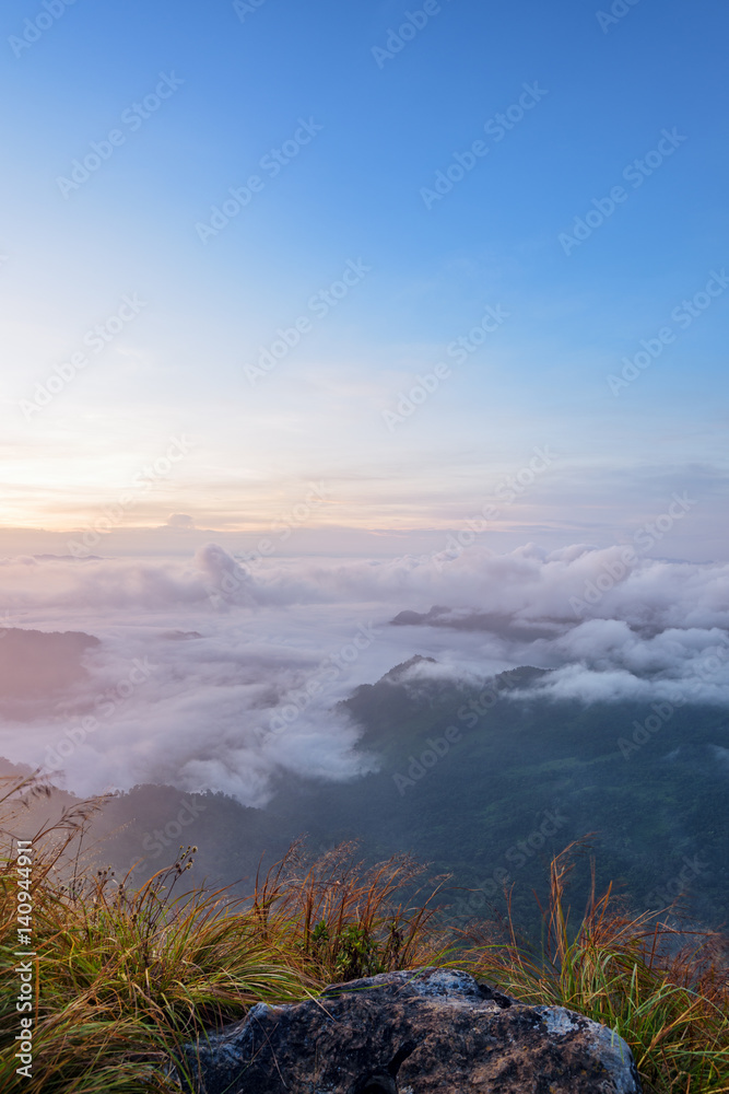 Beautiful landscape nature during sunrise on peak mountain with cloud fog and bright colors of sky in winter at Phu Chi Fa Forest Park is a famous tourist attraction of Chiang Rai Province, Thailand