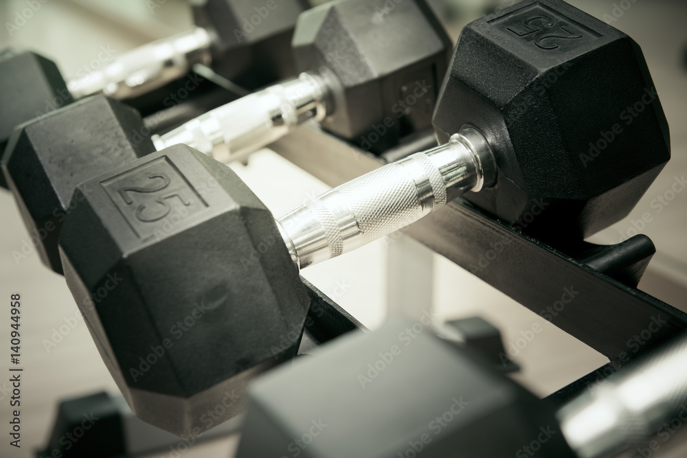 Sports dumbbells in modern sports club. Weight Training Equipment Sports dumbbells in modern sports club. Weight Training Equipment
