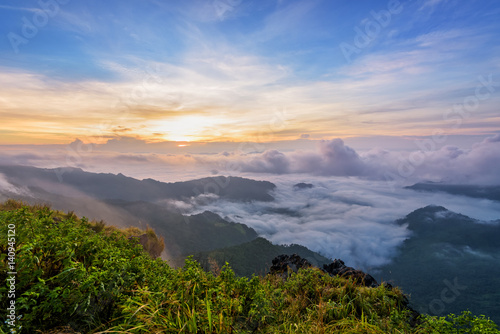 Beautiful landscape nature, sunrise on peak mountain with sun cloud fog and bright colors of sky in winter at Phu Chi Fa Forest Park is a famous tourist attraction of Chiang Rai Province, Thailand © yongkiet