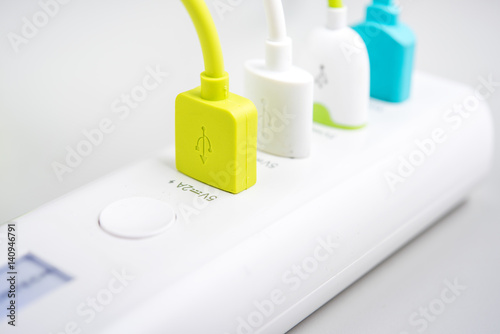 USB plug connected to white adaptor charger