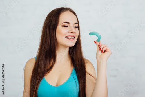 Girl boxer with braces holding gloves and cape photo