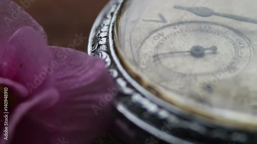 Old silver pocket watch with the second hand moving photo