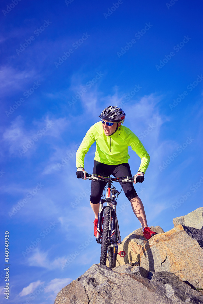 A cyclist who travels in the mountains in summer on a sunny day A cyclist who travels in the mountains in summer on a sunny day