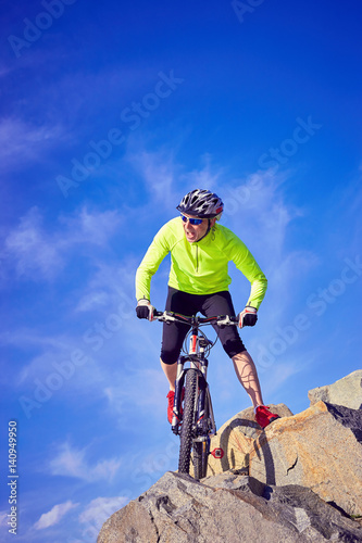 A cyclist who travels in the mountains in summer on a sunny day