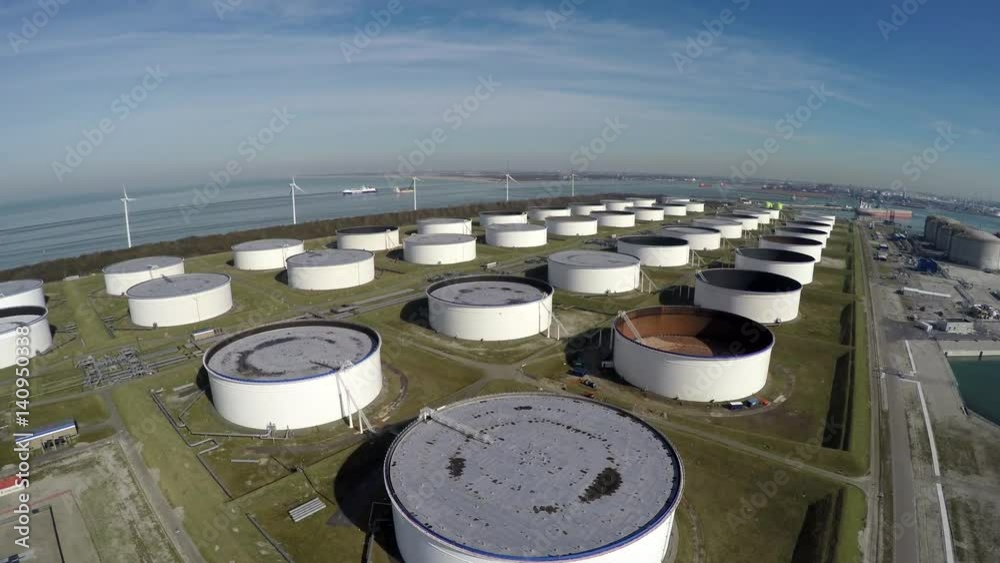 Aerial bird eye view oil depot sometimes called tank farm or oil terminal is industrial facility for storage of oil and petrochemical products ready for transport to further storage facilities 4k Aerial bird eye view oil depot sometimes called tank farm or oil terminal is industrial facility for storage of oil and petrochemical products ready for transport to further storage facilities 4k