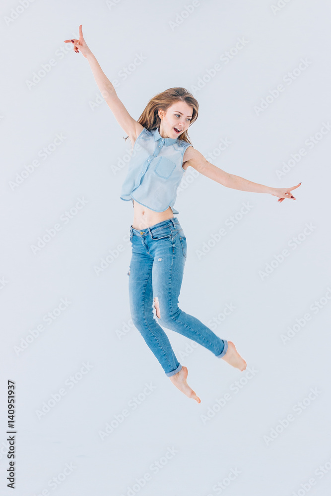 Happy, young, beautiful girl on a white background in a jump Happy, young, beautiful girl on a white background in a jump