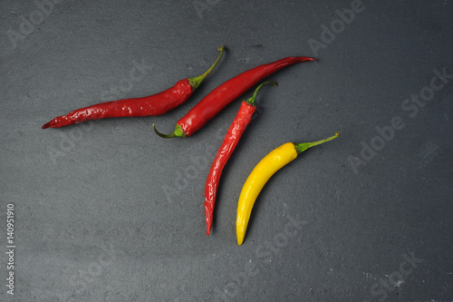 red and yellow chili peppers on black background