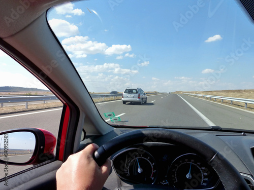 Fast driving on a straight highway on a sunny day