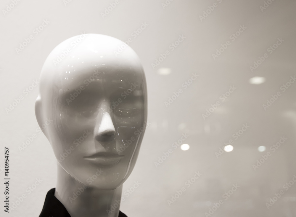 Female mannequin behind glass with glare Female mannequin behind glass with glare