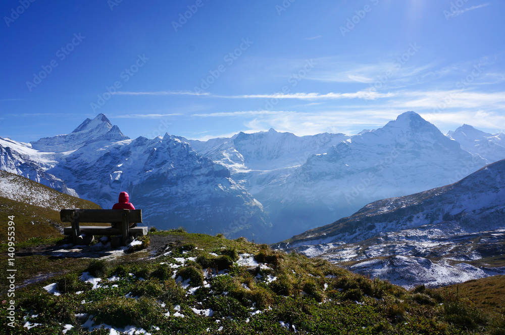 man relax resting on seating after climbing the snow mountains with blue sky, Switzerland