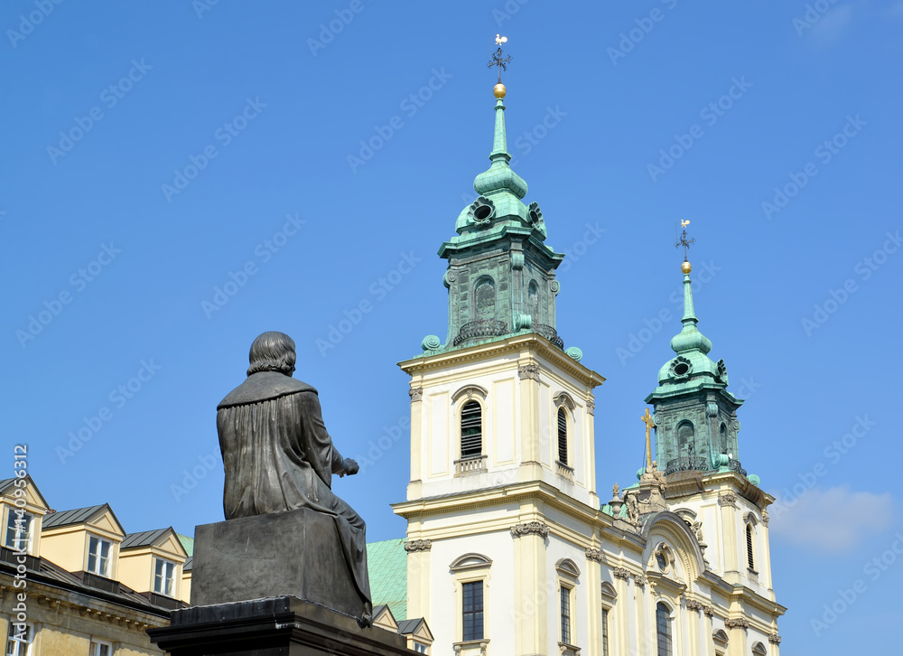 WARSAW, POLAND. A monument to Nicolaus Copernicus and a church of the Sacred Cross against the background of the sky