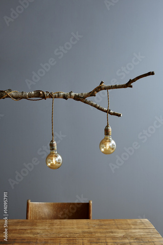 urban interior wooden table and branch lamp