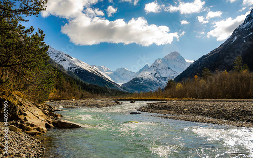 The river flows between the mountains photo