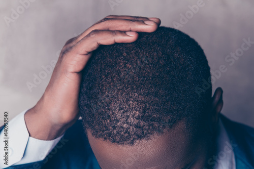 Close up cropped portrait of successful handsome afroamerican man in stylish suit touching his hair