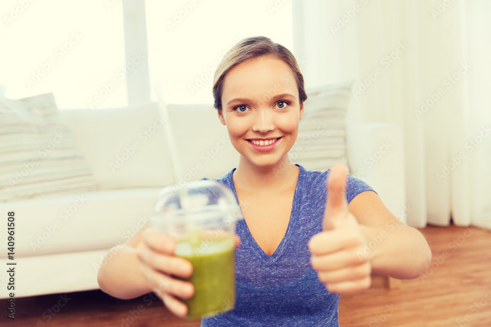 happy woman with cup of smoothie showing thumbs up happy woman with cup of smoothie showing thumbs up