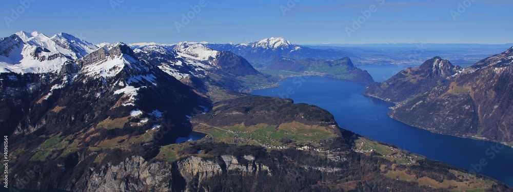 Spring day in the Swiss Alps. Seelisberg, lake Vierwaldstattersee and snow covered mountains. View from mount Fronalpstock.