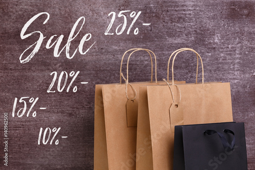 Mockup of blank shopping bags. Sale discounts. Brown and black craft packages. Concept for sales or discounts. Recycled paper.
