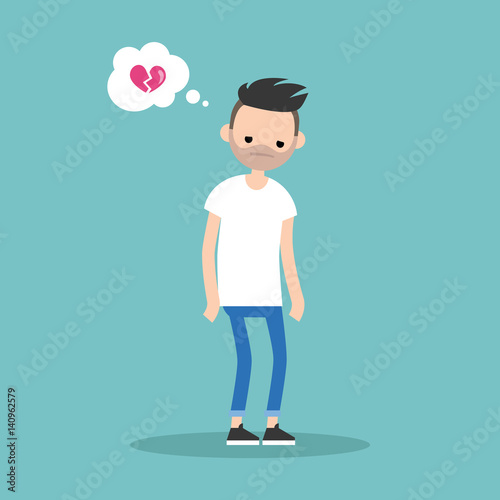 Unrequited love concept young bearded man with a broken heart