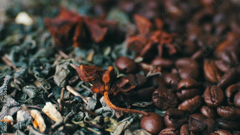 Green tea leaves and coffee beans Anise and sticks cinnamon close up rotation Green tea leaves and coffee beans Anise and sticks cinnamon close up rotation