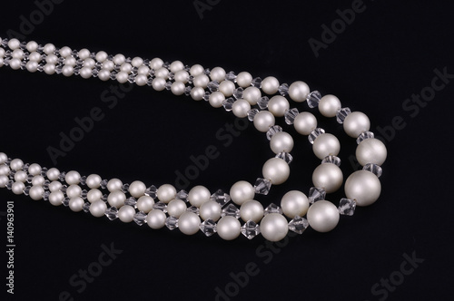 White pearls luxury necklace on black background