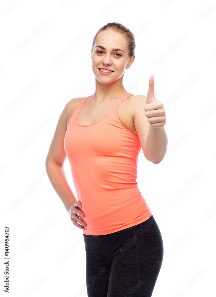 happy sportive young woman showing thumbs up happy sportive young woman showing thumbs up