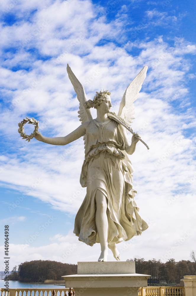 Statue of the goddes Nike, blue sky and clouds