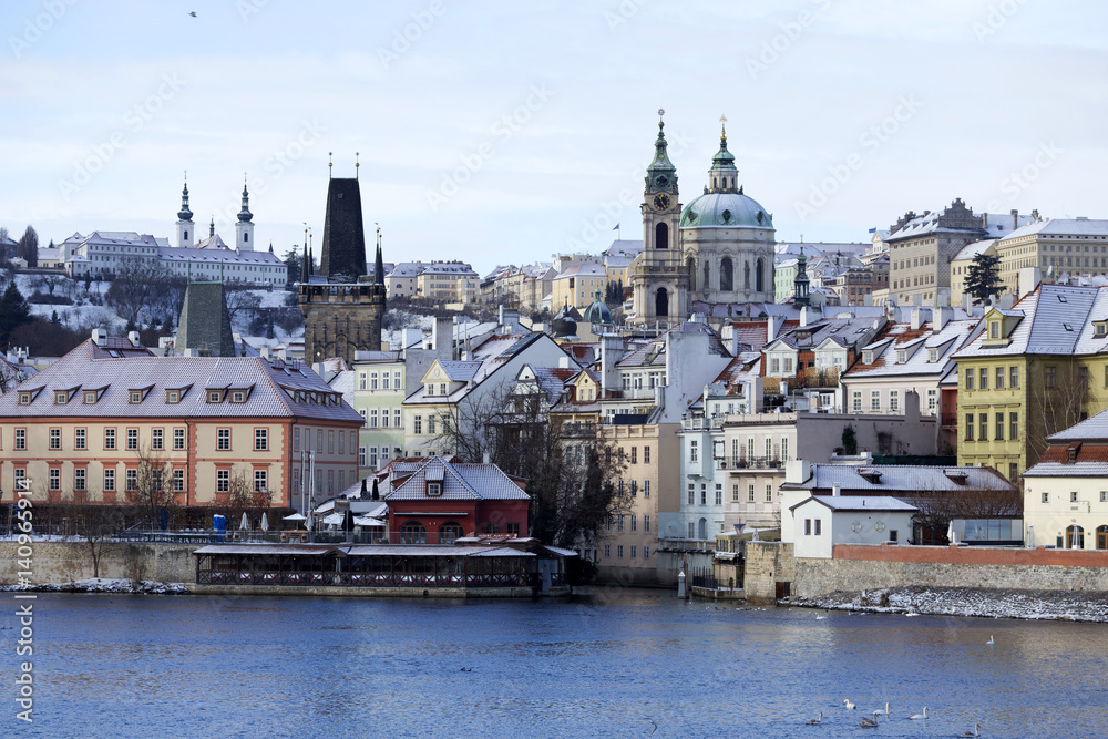 Obraz premium Snowy freeze Prague Lesser Town with St. Nicholas' Cathedral, Czech republic