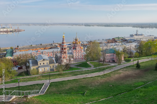 A city landscape with a river, an Orthodox church and bridges in the spring morning. Nizhny Novgorod, Russia