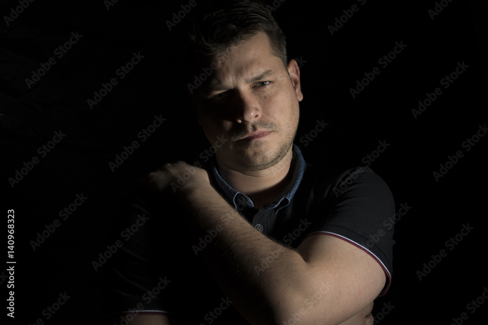Young man portrait isolated on black background