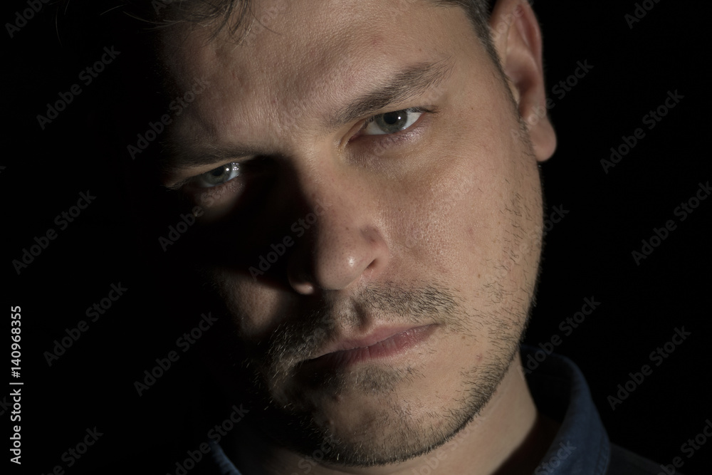 Fototapeta premium Young man portrait isolated on black background