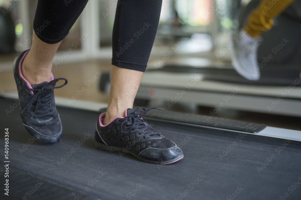 woman running on treadmill in gym woman running on treadmill in gym