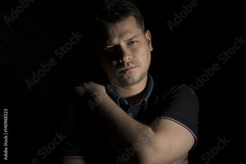 Young man portrait isolated on black background