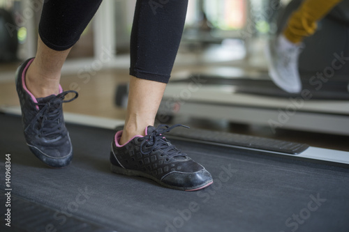 woman running on treadmill in gym