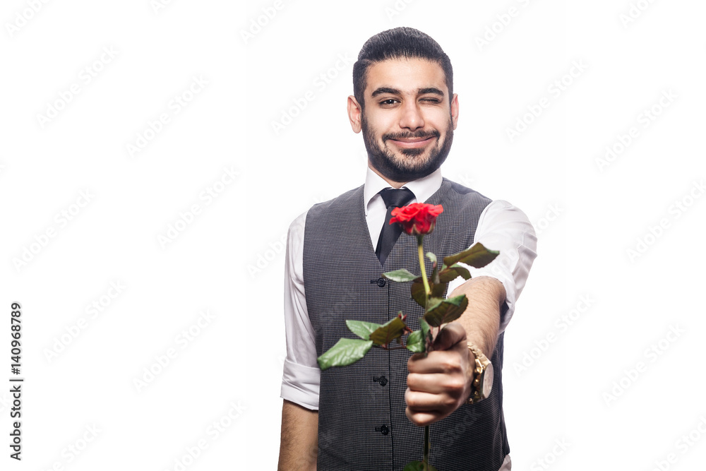 Handsome romantic happy man with rose flower. studio shot. isolated on white background. holding and giving flower and looking at camera and smiling with wink.. Handsome romantic happy man with rose flower. studio shot. isolated on white background. holding and giving flower and looking at camera and smiling with wink..
