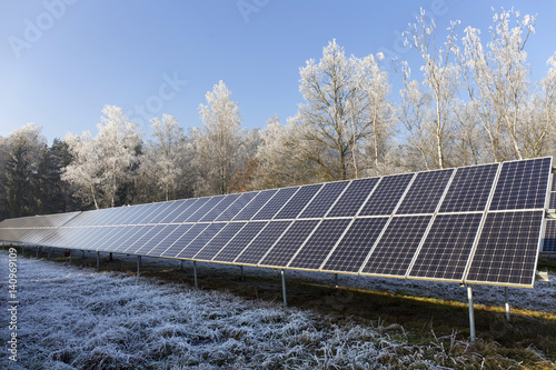Solar Power Station in the snowy freeze winter Nature 