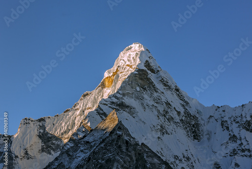 The first rays of the morning sun on the Ama Dablam (6814 m), view from the Chhukhung Ri - Everest region, Nepal photo