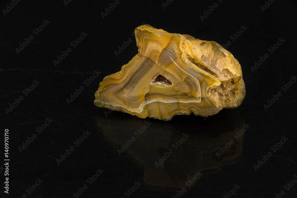 Agate cut on black background from personal collection of Semi-precious stones and minerals Agate cut on black background from personal collection of Semi-precious stones and minerals