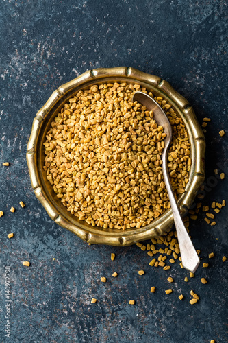 Fenugreek seeds on metal plate, spice, culinary ingredient