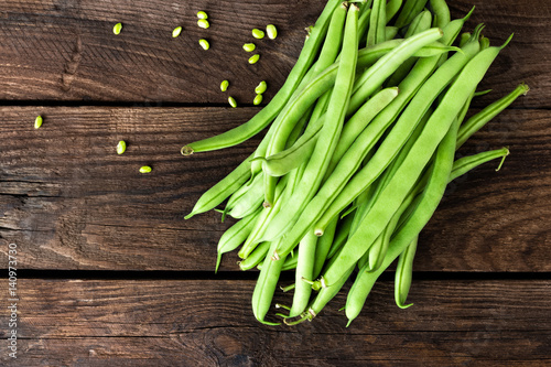 Fresh green beans on dark wooden rustic background top view copy space flat lay photo