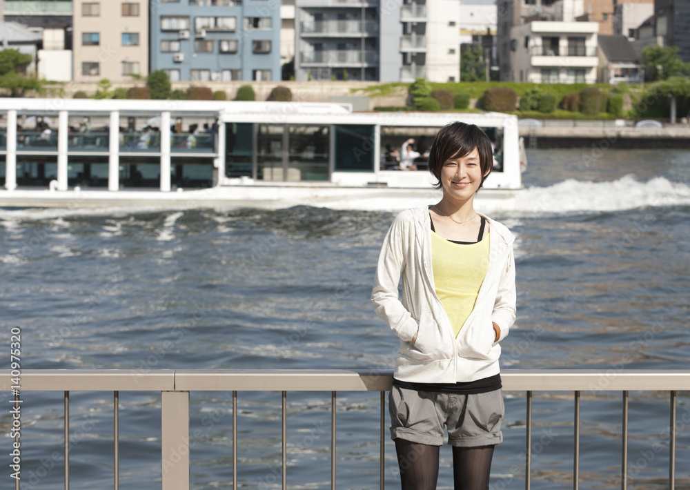 Young woman standing beside river Young woman standing beside river