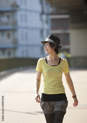 Young woman walking on bridge © imagenavi