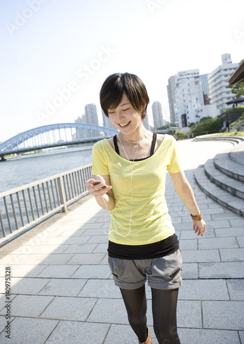 Young woman walking along river