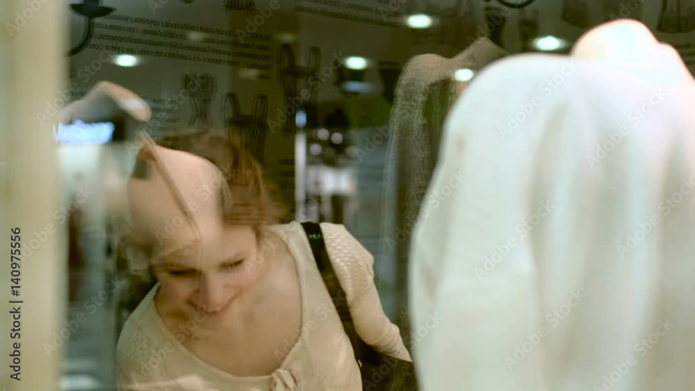 People and fashion, portrait of happy young woman smiling and trying out dress in clothing store People and fashion, portrait of happy young woman smiling and trying out dress in clothing store