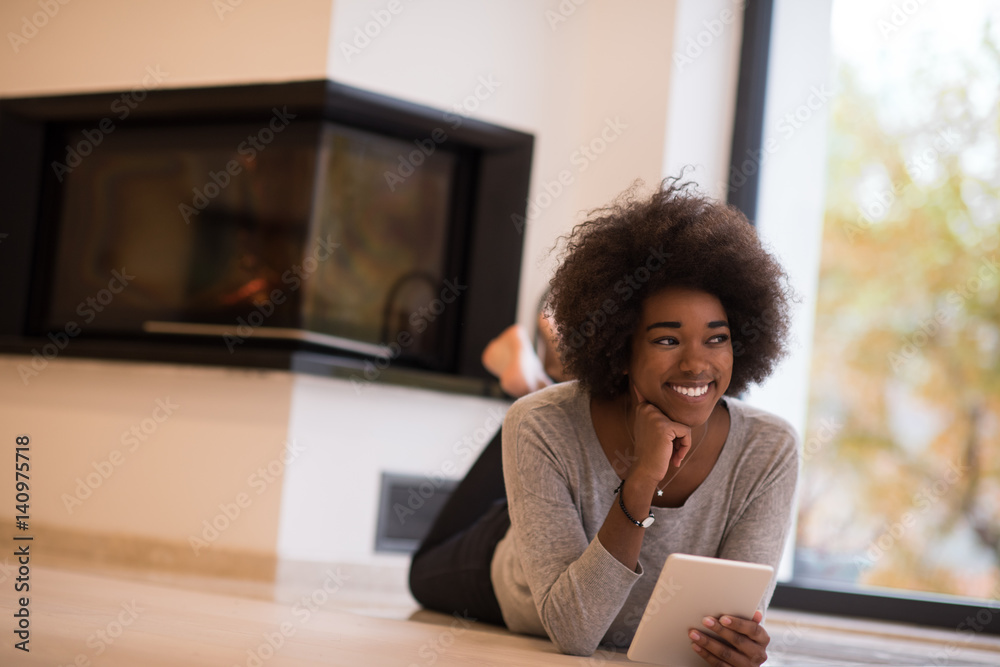 black women using tablet computer on the floor - obrazy, fototapety, plakaty 