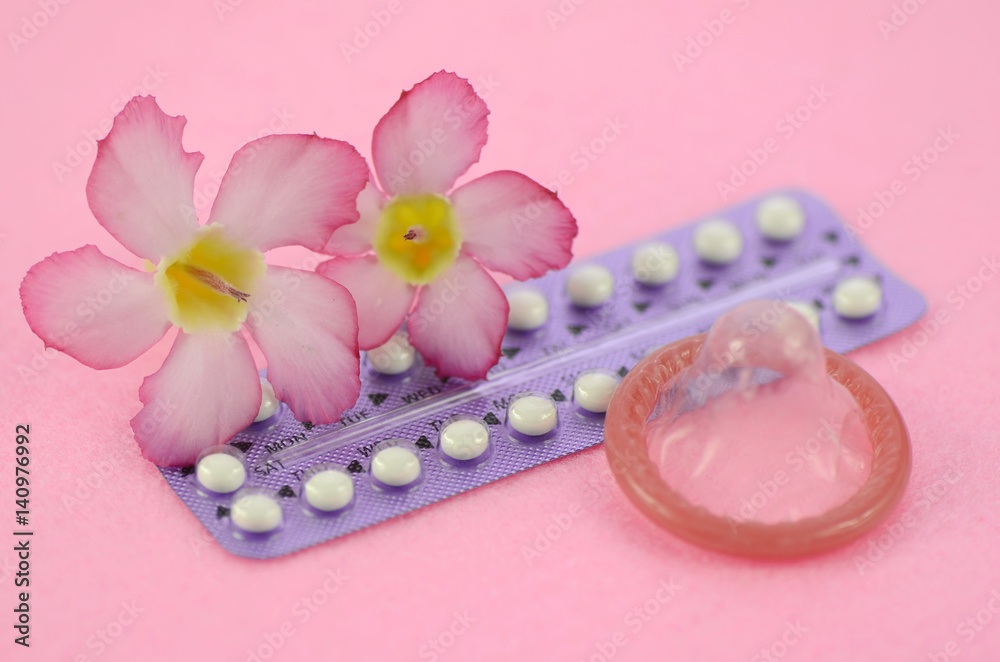 Oral contraceptive on pink background in women health concept. Oral contraceptive on pink background in women health concept.