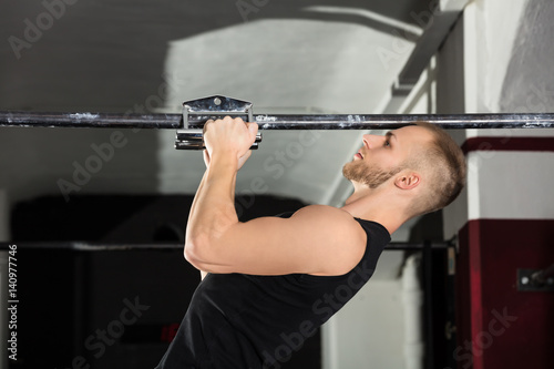 An Athlete Man Doing Narrow Grip Pullup Exercise