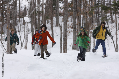 Young people running with snowshoes