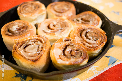 Homemade cinnamon rolls in iron pan.