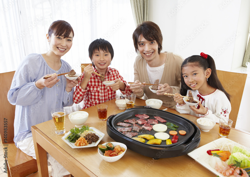 Parents and kids eating Japanese barbeque
